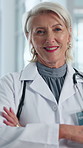 Crossed arms, woman and face of doctor in hospital with confidence for career in medical service. Happy, about us and portrait of mature cardiologist with pride for healthcare support at clinic.
