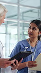 Meeting, doctor and nurse on tablet in hospital for surgery schedule, planning and patient review. Healthcare, discussion and women with tech, paperwork and report for wellness and medical service