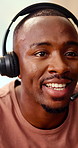 Headset, talking and business man in office for customer support, online help and contact us. Consultant, communication and African person with mic for virtual assistance, crm service and feedback