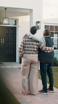 Back, old couple and hug at new house for viewing, property purchase and relocation. Senior people, discussion and front door with embrace, home selection and retirement investment for real estate