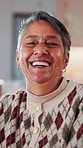 Face, senior and happy woman laughing in home with pride for humor, comedy or retirement. Portrait, elderly or female person with smile or positive attitude for pension, holiday or weekend in house