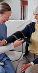 Nurse, old woman and strap for blood pressure exam, testing and preparation in medical appointment. Caregiver, sphygmomanometer and senior person in nursing home for help with hypertension diagnosis