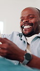Mature, man and laugh in house with phone, funny online news or humor for social media notification. Happy, black person and browsing in home with tech, internet connection or joke from text message.