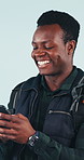 Phone, laugh and black man in studio for backpacking on holiday, getaway or weekend trip with texting. Happy, hiking and person with cellphone for social media or internet meme on white background.
