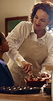 Baking, mom and child with mixing in house for chocolate cake, teaching family recipe and support. African people, happy mother or boy with batter for muffin snack mixture, culinary skills or bonding