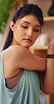 Serious, woman and stretching in house, yoga and physical activity to improve posture and endurance. Fitness, home and person with balance, self care and warm up routine for wellness in apartment