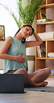 Yoga, stretching and woman with laptop in house, physical activity and watching fitness tips on web. Warm up routine, home and person with technology, serious and self care tutorial on social media
