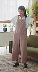 Headphones, dance and happy woman in home living room with energy, smile and music playlist. Student, female person and audio equipment for streaming, good mood and beat with rhythm and moves