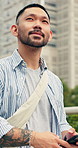 Walking, phone and asian man in city for sightseeing, outdoor travel or tourism in an urban town. Thinking, male person or tourist with vision, view or smartphone for commute, journey or adventure