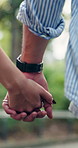 Couple, walking and holding hands in park for romance, love or outdoor bonding together. Man, woman or care with commitment, partnership or relationship for travel, commute or holiday in nature