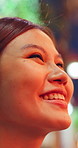 Happy, thinking and asian woman in night for tourism, outdoor travel or sightseeing trip in town. Thoughtful, female person or wonder with smile or view in late evening for memory or moment in city