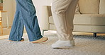 Feet, dancing and energy in home lounge for fun, bonding and steps with rhythm or music. Family house, woman and legs to learn jazz or movement together in living room with healthy relationship