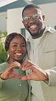 Face, couple and heart hands outdoor with new house, property investment or happy with real estate. Married, black people and love sign in front yard with relocation, support or moving in dream home.