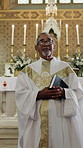 Bible, man and face of pastor in church for sermon, blessing or gospel to congregation for worship. Faith, portrait and priest with preach or scripture in spiritual book for religion in holy building