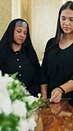 Sad, people and flower at funeral with coffin, condolences and memorial service for deceased. Family, widow or rose on casket at church for remembrance, final goodbye and burial for farewell ceremony