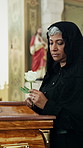 Sad, woman and flower at funeral with coffin, condolences and memorial service for deceased. Mature person, widow or rose on casket at church for remembrance, goodbye and burial for farewell ceremony