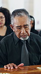 Sad, man and mourning at funeral with coffin, condolences or memorial service for deceased. Family, grieving and widower with casket at church for rip, final goodbye and burial for farewell ceremony