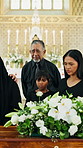 Sad, people and grief at funeral with coffin, condolences and memorial service for deceased. Family, mourning and flowers with casket at church for rip, final goodbye and burial for farewell ceremony