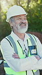 Happy, architect and man at construction site with arms crossed, hard hat and property development. Confident, mature person and smile outdoor with PPE, building project and architecture inspection.