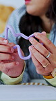 Sensory, hands or university student on bed with toy, regulation or stress relief in stimulation. Wellness, fidget or woman in home with nerves, academic anxiety or mindful movement with calming tool