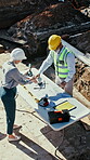 Architect, handshake and people outdoor at construction site with blueprint, building and excavation. Above, man and woman shaking hands for teamwork, collaboration and civil engineering deal