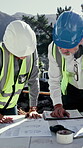 Engineer, blueprint and people outdoor at construction site with discussion, building or excavation. Floor plan, mature man and woman together for teamwork, collaboration or civil engineering project