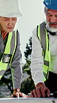 Architect, floor plan and people outdoor at construction site with discussion, building or excavation. Blueprint, mature man and woman together for team, collaboration or civil engineering project