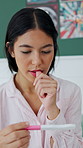 Pregnancy test, anxiety and woman on bed in home with concern for family planning or bed news. Maternity, mistake and person with fertility stick in bedroom with nervous, scared or stress in house.