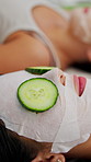 Relax, cucumber and girl friends with face mask in home for skincare, beauty and wellness on weekend. Unwind, cosmetic and women with fruit for cleansing pores, health or facial treatment in house.