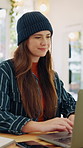 Student, typing and girl on laptop in cafe for online assignment, project and research. Happy, coffee shop and person on computer for studying, essay or learning for university, education and college
