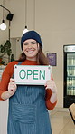 Hospitality, face and woman in cafe with open sign, cardboard notice and welcome to small business. Happy, portrait and owner with billboard, service ready and greeting display for restaurant startup