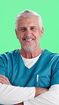 Face, man and surgeon in studio with confidence, smile and about us on green background. Portrait, mature person or happy nurse with arms folded for medical healthcare, career integrity or experience