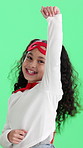 Face, child and superhero flying in studio with smile, pretend and wind on green background. Flight, cape and girl with costume, cosplay dress up or portrait of excited kid with fantasy superpower