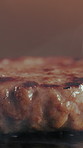 Grill, burger and patty in restaurant with steam, cuisine preparation or cooking meat for fast food. Heat, raw beef and protein in kitchen with smoke, catering service and hospitality for lunch meal
