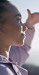 Hiking, woman and view on holiday outdoor, sightseeing or thinking on adventure with happiness. Smile, tourist and person in nature for vacation, trekking and reflection for travel with wanderlust