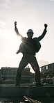 Engineer, fist pump and happy on construction site for building success, architecture and finish. Architect, male person and flare for civil engineering, winning and deadline completion on rooftop