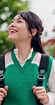 Thinking, Asian woman and student in city with smile, vision and daydreaming for learning abroad. Happy, female person or walking in town for morning commute, reflection and scholarship for education