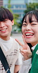 Face, friends and selfie in city with peace sign, smile and bonding together for travel memories. Happy, Japanese people outdoor and v gesture in urban town with picture, social media or tourist trip