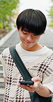 Text, phone or college student in city with connection, online chat or social media scroll on commute. Typing, digital or Asian man with tech, university email or message notification in urban travel