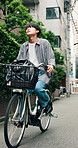 Travel, smile and man with bike in town for morning commute, adventure and journey. Explore, cycling and Japanese person on bicycle for urban trip, sustainable or eco friendly transport outdoors
