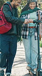 Smile, students and help in nature with electric scooter, partner support and travel to university. Happy, couple and guidance at park with transport, eco friendly and commute for learning journey