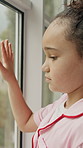Window, thinking and sad child with depression, neglect or remember memories for foster care trauma. Orphan, reflection and girl with mental health, adoption crisis or abandoned with despair in home.