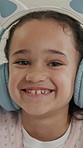 Happy, face and child in home with headphones for online streaming, entertainment and music. Smile, portrait and girl with audio for movie subscription, videos and cartoons to relax on weekend