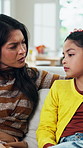 Mother, sad kid and talking in home for support, family advice and help with parent guidance. Worry, mom and unhappy girl with conversation at apartment for concern, care or comfort with empathy