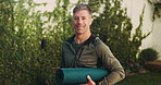 Yoga mat, happy and face of man in nature with confidence for exercise, health or wellness. Morning, fitness and portrait of mature person with equipment for pilates, calm or relax outdoor in park.