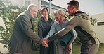 Senior, friends and hands together in backyard for fitness, exercise or mission on grass field. Health, elderly group or people piling with stack or smile in unity for outdoor wellness or teamwork