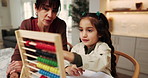 Mother, child and learning in home with abacus, homework discussion and practice math for development. Woman, talk and daughter in house with counting tool, school assessment and help for education.