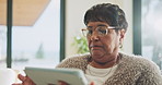 Senior, woman and scroll in home with tablet, glasses and search website for ebook on weekend break. Pensioner, person and internet in house with tech, reading news article and relax for retirement.
