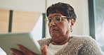 Senior, woman and scroll in house with tablet, glasses and search website for ebook on weekend break. Pensioner, person and internet in home with tech, reading news article and relax for retirement.