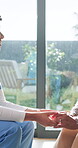 Smile, nurse and holding hands with old woman, home care and medical support with conversation. Trust, comfort and caregiver with person in retirement, talking and healthcare advice with wellness